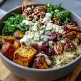 A vibrant Harvest Kale Quinoa Bowl with crisp massaged kale, crunchy pecans, and sweet dried cranberries.