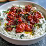 Tangy feta blended smooth, served with caramelized cherry tomatoes and a drizzle of olive oil.  