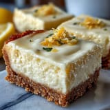 Tangy, no-bake Skyr Lemon Cheesecake Bars garnished with fresh berries, a refreshing dessert.