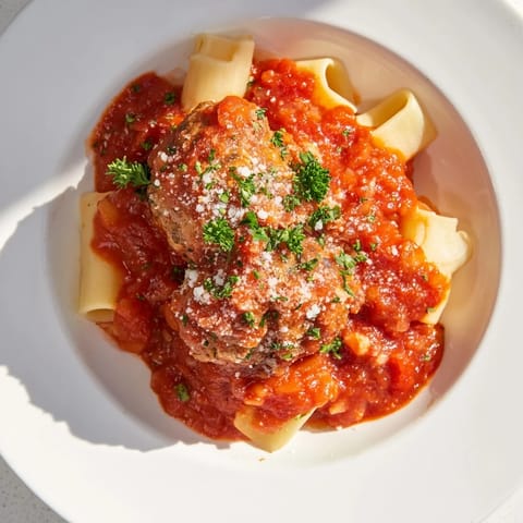 Juicy turkey meatballs with herbs and Parmesan cheese, simmering in a flavorful tomato sauce.