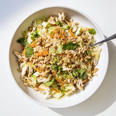Forkful of Crunchy Ramen Chicken Salad with crisp carrots, scallions, and crushed instant noodles, ready for a quick lunch or potluck.
