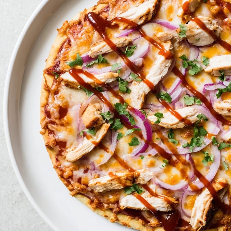 This Chicken BBQ Pizza features a crispy crust, smoky barbecue flavors, and delicious toppings ready to eat.