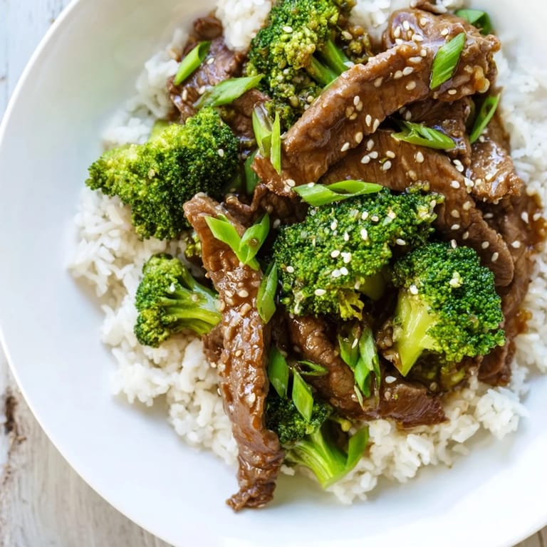 Close-up of a steaming bowl of Beef and Broccoli, a classic, flavorful Chinese-American dinner.