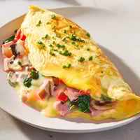 Golden omelet with cheese, fluffy and folded, ready to eat for a delicious breakfast.